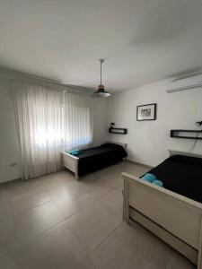 a living room with two beds and a couch at Alquiler de casa zona Cerro in Cordoba