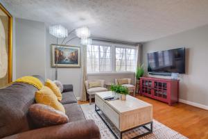 a living room with a couch and a tv at Quaint Arlington Vacation Rental with Patio! in Arlington