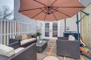 a patio with an umbrella and chairs and a table at Quaint Arlington Vacation Rental with Patio! in Arlington