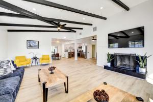 a living room with a couch and a fireplace at Stylish Palm Springs Home with Outdoor Oasis! in Palm Springs