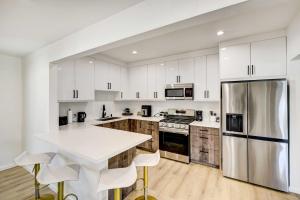 a kitchen with white cabinets and a white counter top at Stylish Palm Springs Home with Outdoor Oasis! in Palm Springs