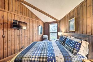 a bedroom with a bed in a room with wooden walls at 1/2 Mi to Skiing! Beech Mountain Cabin w/ Deck in Beech Mountain