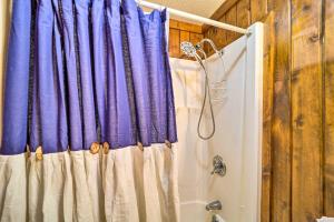 a shower with a purple shower curtain in a bathroom at 1/2 Mi to Skiing! Beech Mountain Cabin w/ Deck in Beech Mountain
