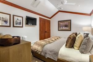 a bedroom with a bed and a flat screen tv at Exclusive 4 Bedroom Ski In, Ski Out Vacation Rental With Hot Tubs And Heated Outdoor Pool In Lionshead Village in Vail