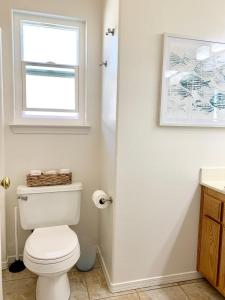 a bathroom with a white toilet and a window at Pismo Beach Rental in Pismo Beach +25 photos