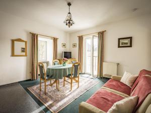 a living room with a table and a couch at Haus Alpenruhe in Bad Reichenhall
