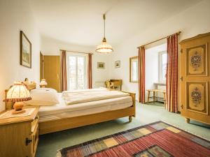 a bedroom with a large bed and a table at Haus Alpenruhe in Bad Reichenhall