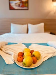 a plate of fruit on a table with a bed at Asteria Hotel Sirkeci in Istanbul