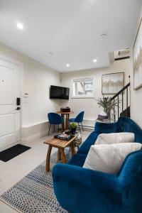 a living room with a blue couch and a table at Parker Guest House in Vancouver