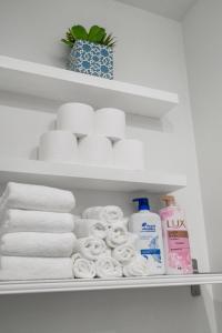 a shelf with towels and toiletries in a refrigerator at Parker Guest House in Vancouver