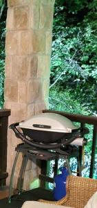 a grill sitting on a table on a porch at Tranquil Garden Nest in Nelspruit