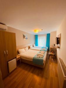 a hotel room with a bed and a television at Asteria Hotel Sirkeci in Istanbul