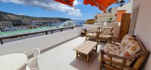 a balcony with a table and chairs on a ship at La colina in Arona