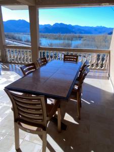 een tafel en stoelen op een balkon met uitzicht bij Skadar Lake Apartment -Anja in Vranjina