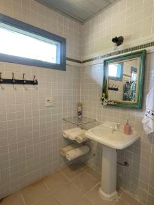 a bathroom with a sink and a mirror at Casa das Orquídeas in Lavras Novas