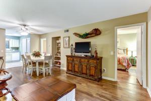 a living room with a television and a dining room at 8A Amelia Landings Condo in Fernandina Beach