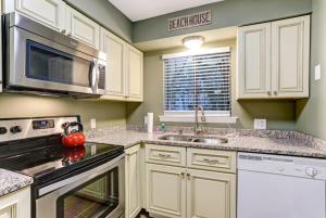 a kitchen with a sink and a stove top oven at 8A Amelia Landings Condo in Fernandina Beach
