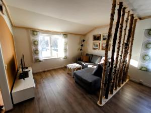 a living room with a couch and a window at Exklusiv flat with office 25 min from Östersund 