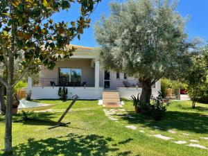 a house with a hammock in the yard at Apollon Paian , Luxury Nature Relax in Lefkada