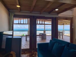 a living room with a view of the ocean at El Mangle Suite Front Beach in Ayampe
