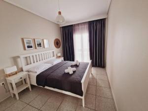 a bedroom with a bed with two candles on it at Viktoria Sea View Apartment in Perea