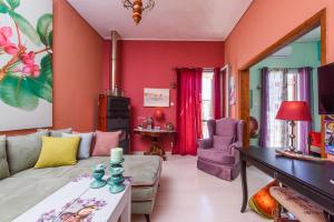 a living room with a couch and a table at Aegina's Flowers house in Egina