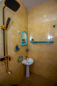 a bathroom with a sink and a shower at AJI Warm 2BED Apartment (Ijegun, Lagos) in Lagos