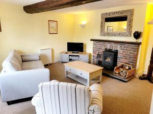 a living room with a couch and a fireplace at One Bed Ground Floor Apartment- Great Getaway 