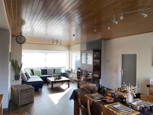 a living room with a couch and a table in it at Casa K in Middelkerke