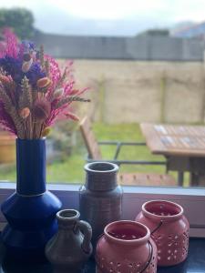 a group of vases and flowers on a window sill at Casa K in Middelkerke +44 photos