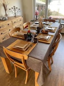 a wooden table with chairs and a dining room at Casa K in Middelkerke