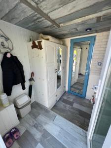 a small bathroom with a toilet and a door at Вила Вилекула in Varna City +16 photos