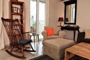 a living room with a couch and a chair and a table at Amazing penthouse in Ambelokipi in Athens