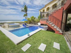 a house with a swimming pool next to the ocean at Mazatln Villa Del Mar With Pool in Barrón
