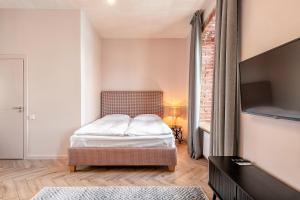 Postel nebo postele na pokoji v ubytování Adler Aparthotel