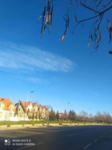 an empty street with houses and a blue sky at N36 Residence Amine pour famille in Ifrane