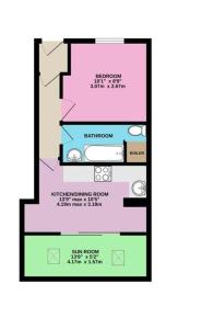 a floor plan of a building with pink and green at Apartment in central Exmouth in Exmouth