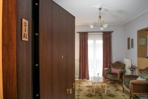 a room with a door and a living room with a chair at 4keys House - Superior in Tripoli +35 photos