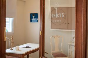 a room with a table and a chair and a mirror at 4keys House Superior in Tripoli