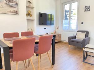 a dining room with a table and chairs and a television at Sweet Home Paradise in Villers-le-Lac