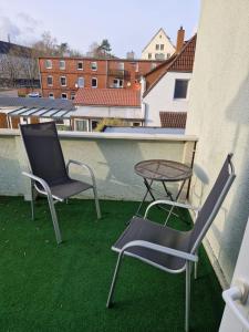 two chairs and a table on a roof at Haus Regine in Rendsburg