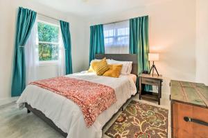 a bedroom with a large bed with green curtains at Bright, Pet-Friendly Retreat in Avon Park! in Avon Park