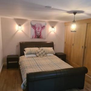 a bedroom with a bed and two lights on the wall at The Coach House in Blackpool