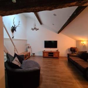 a living room with a couch and a television at The Coach House in Blackpool