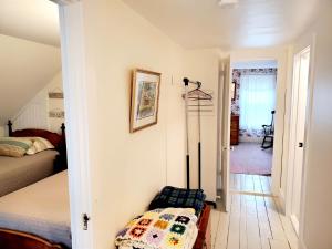 a bedroom with a bed and a room with a bed sqor at 38 Pleasant Street Harwich Port - Pleasant Street Cottage in Harwich Port