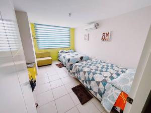 Ένα ή περισσότερα κρεβάτια σε δωμάτιο στο Paradise departamento para vacacionar