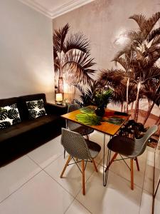 a living room with a table and chairs and a couch at Copacabana in Beach in Rio de Janeiro