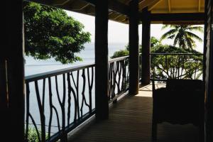 a view of the ocean from the porch of a house at Beachfront Villa - Pod House, Private Plunge Pool in Savusavu