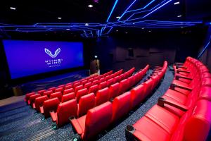 an auditorium with red chairs in front of a screen at Viimsi Spa & Waterpark in Tallinn