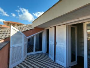 a balcony with white shutters on a house at Attico Chiavari in Chiavari